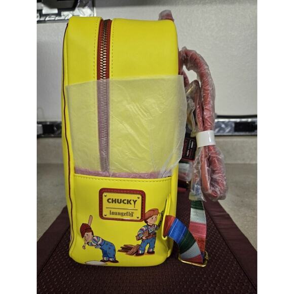 The Must-Have Chucky Loungefly Bag for the Spooky Season Chucky Halloween loungefly backpack has see-through plastic in the middle